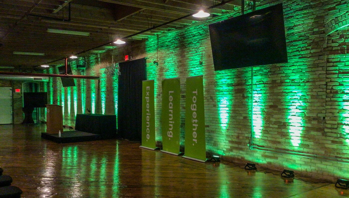 corporate event at event center with green uplighting